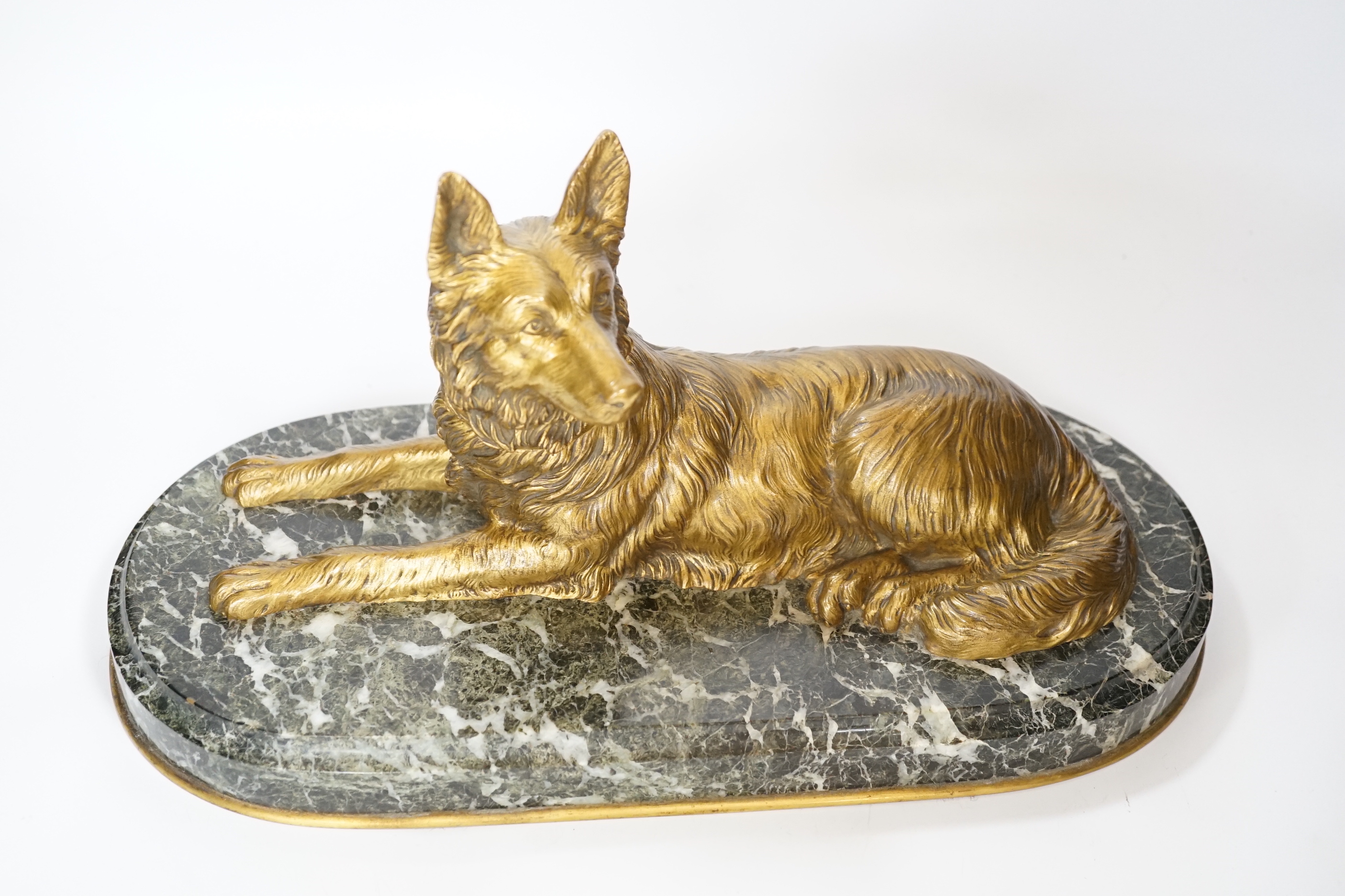 A recumbent dog gilt bronze on marble plinth, style of Chiparus, 40cm long